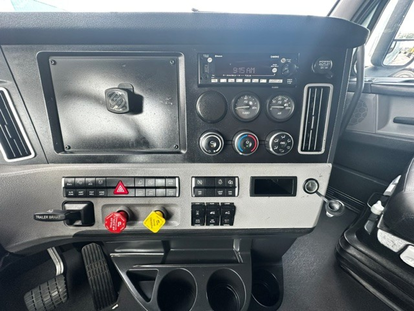 Freightliner Cascadia dash with control panels, gauges, and radio showing dashboard hardware