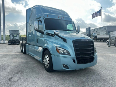 Truck cab front-left view of a blue 2023 Freightliner Cascadia 126 sleeper tractor.
