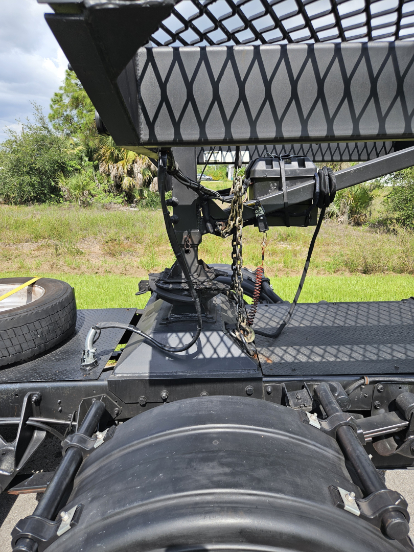 Truck hitch area with chains and wiring on a dodge ram 2021 truck bed. Partial spare tire visible.