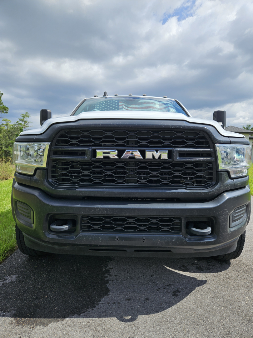 Front view of a Dodge Ram truck showing bold RAM grille and headlights.