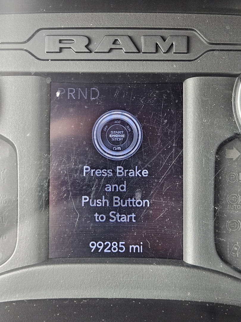 Ram dashboard display showing start/stop button with ‘Press Brake and Push Button to Start’ and odometer reading 99285 mi.