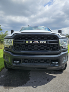 Front view of a Dodge Ram truck showing bold RAM grille and headlights.
