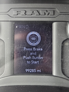 Ram dashboard display showing start/stop button with ‘Press Brake and Push Button to Start’ and odometer reading 99285 mi.