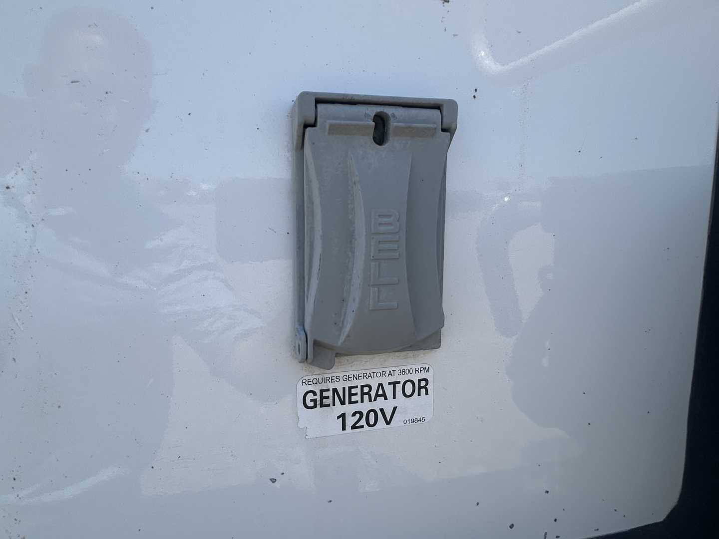 Panel with 120V generator tag on Mack MD642 truck showing generator 120V label and BELE switch cover.