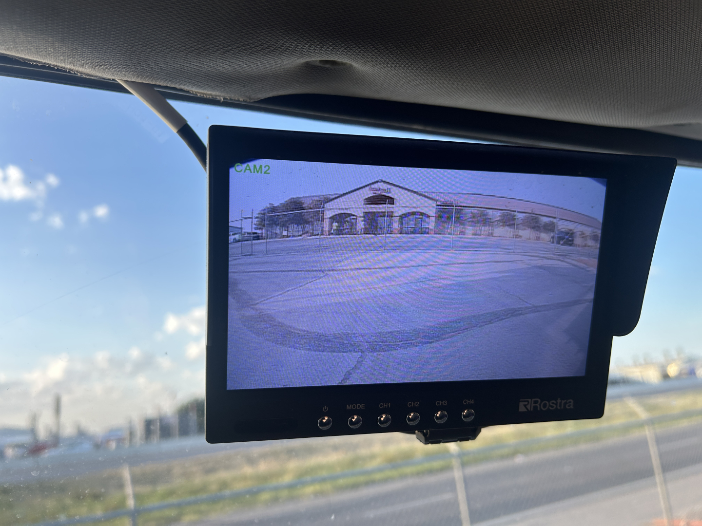 Mack MD642 service truck interior rear camera monitor showing a building exterior.