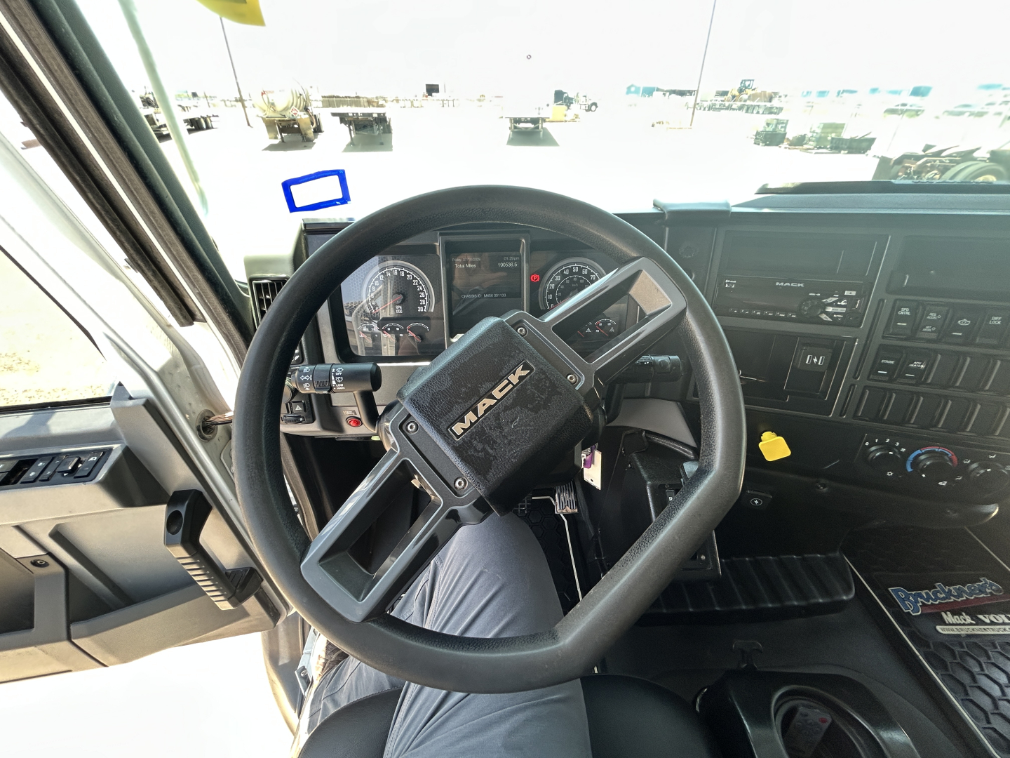 Mack MD642 cab interior showing steering wheel and dashboard with gauges and controls.