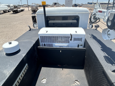 Mack MD642 truck bed showing air conditioning unit and equipment rack in cargo area.