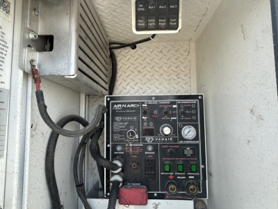 Mack MD642 service truck interior showing Ryanair air conditioning control panel and diagnostic gauges.