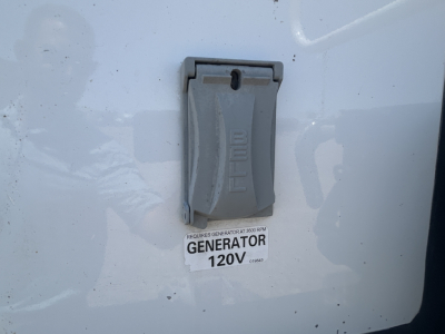 Panel with 120V generator tag on Mack MD642 truck showing generator 120V label and BELE switch cover.