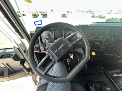 Mack MD642 cab interior showing steering wheel and dashboard with gauges and controls.