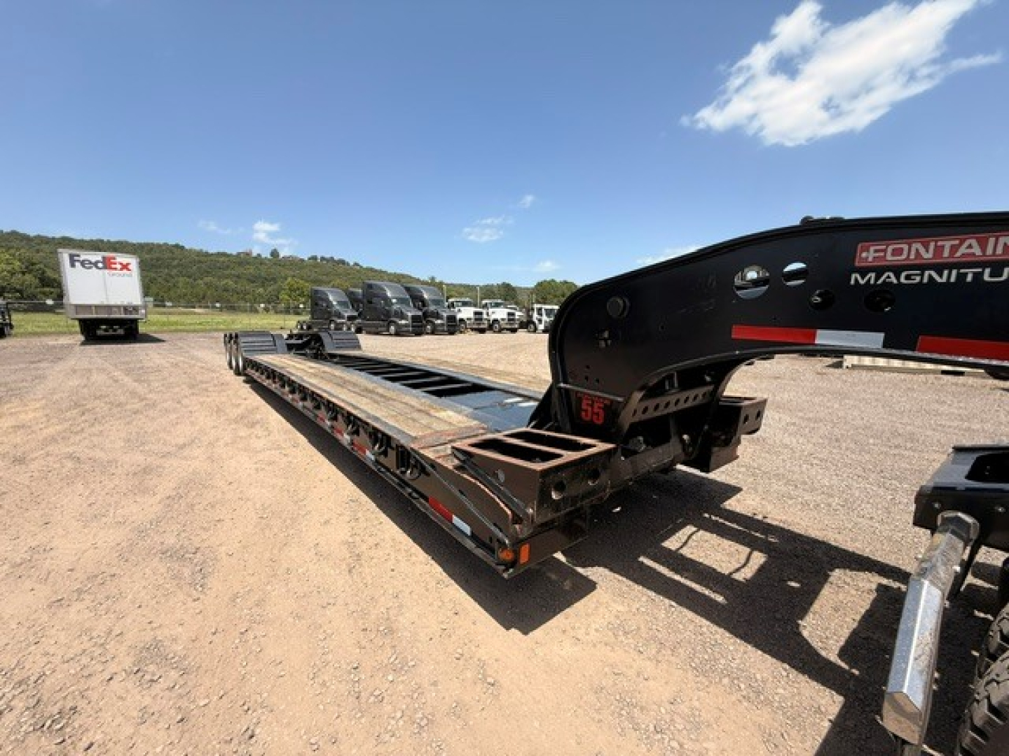 Lowboy trailer with MAG55H Fontaine load deck showing long steel frame and hydraulic gooseneck area