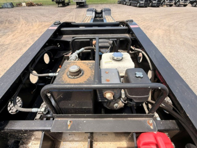 Fontaine MAG55H lowboy trailer engine bay showing fuel tank, hydraulic reservoir, coolant reservoir, and adjacent components.