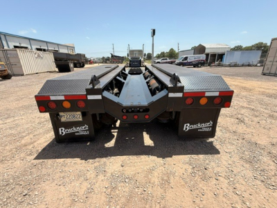 Rear view of a Fontaine MAG55H lowboy trailer with dual wheel fenders, taillights, and loading ramps, stock number B3738P displayed.
