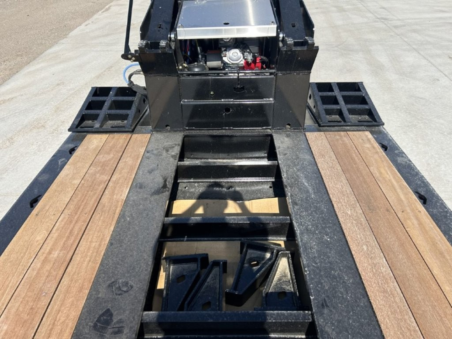 Trailer deck and gooseneck of 2027 Alpha A110HDG-SF-18 inch LDH lowboy showing wooden deck planks and hydraulic components.