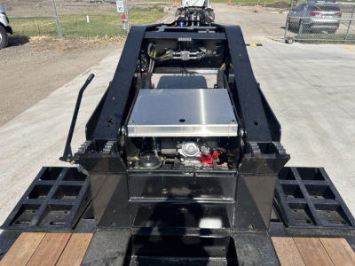 Trailer hitch mounting area with hydraulic tank and metal framework; 18-inch LDH lowboy trailer components visible.