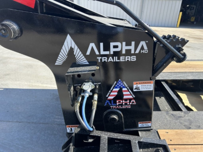 Alpha Trailers A110HDG-SF LDH 18" deck lower front side showing Alpha Trailers logo, hydraulic hoses, and warning stickers.