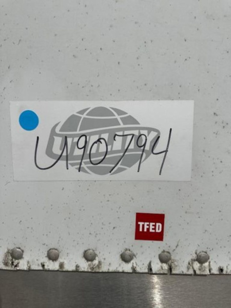Stickered van trailer showing stock number U90794 handwritten over a label and a TFED/TFED badge near the bottom edge.