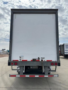 Wabash van trailer rear view showing rear doors and bumper with reflective tape and lights.