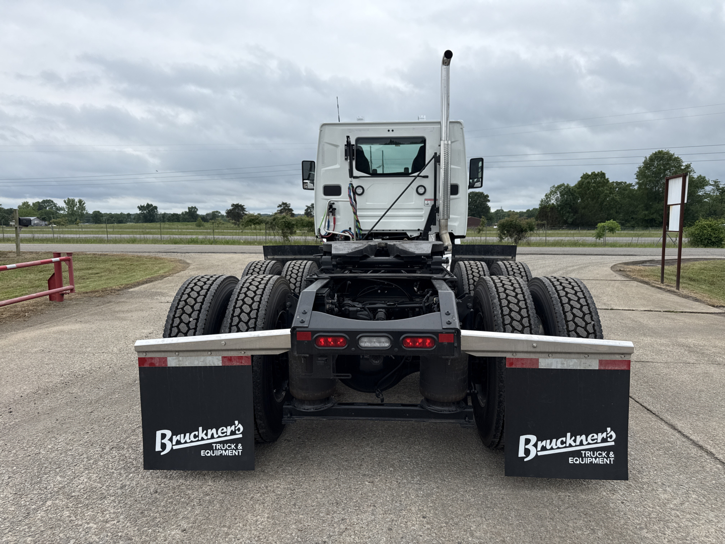 Truck chassis back view showing dual rear axles and mud flaps with Bruckner's Truck & Equipment logos