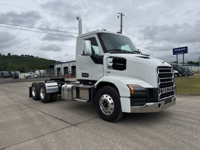 Truck: 2027 Mack AN64T conventional daycab with white exterior, front grille, dual exhaust, cab mirrors, and six-wheel configuration parked in a lot.