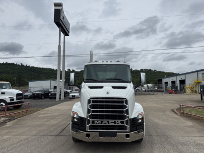 Mack AN64T conventional daycab truck front view in a dealership lot showing bold grille, chrome bumper, and Mack emblem.