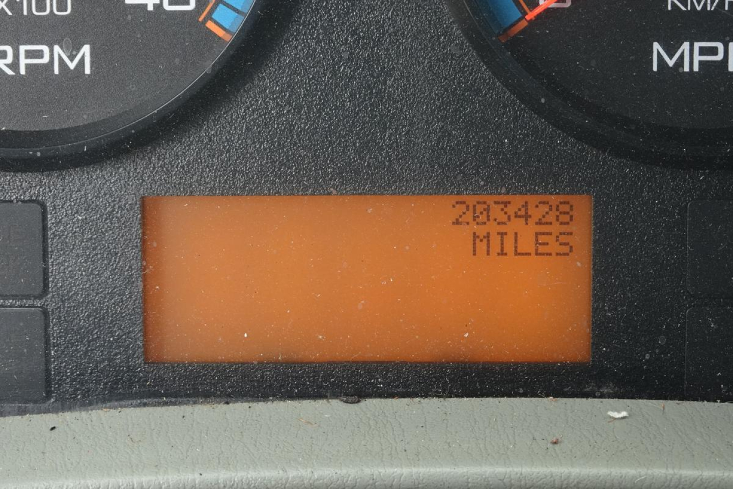 Dashboard odometer reading showing 203428 miles on an orange digital display.