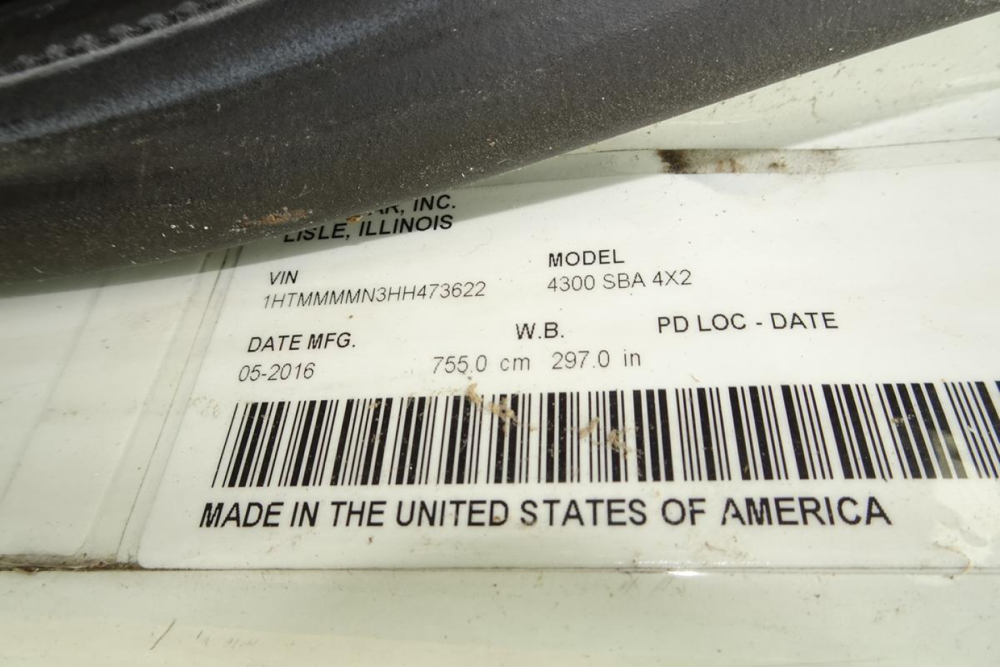 VIN label on International 4300 SBA truck showing VIN 1HTMMMMN3HH473622, model 4300 SBA 4X2, date 06-2016, wheelbase 297.0 in, 755.0 cm, Made in the United States of America.