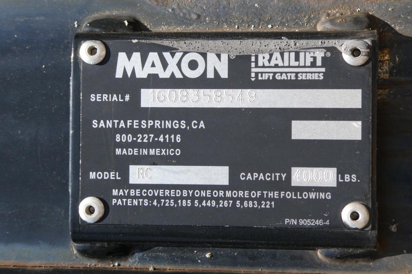 Maxon Railift lift gate series plate on a vehicle showing serial number, Santa Fe Springs CA, 800-227-4116, MADE IN MEXICO, MODEL RC, CAPACITY 4000 LBS, P/N 905246-4.