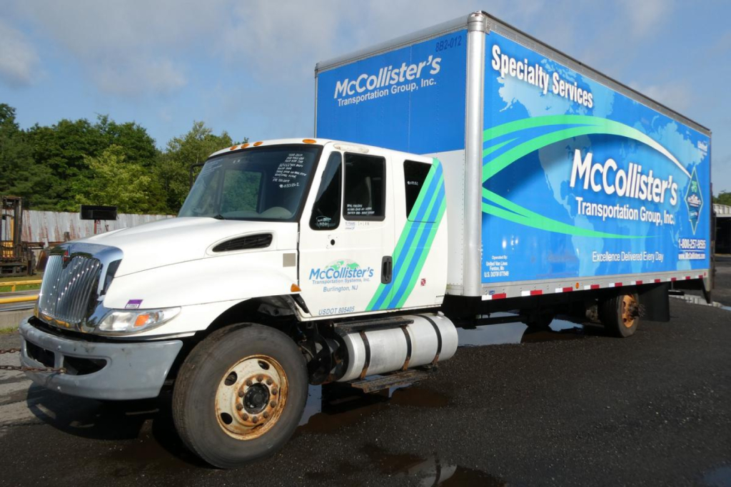 Box truck showing McCollister's Transportation Group, Inc. livery on a 2017 International 4300 SBA with cab and cargo box.