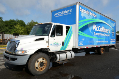 Box truck showing McCollister's Transportation Group, Inc. livery on a 2017 International 4300 SBA with cab and cargo box.