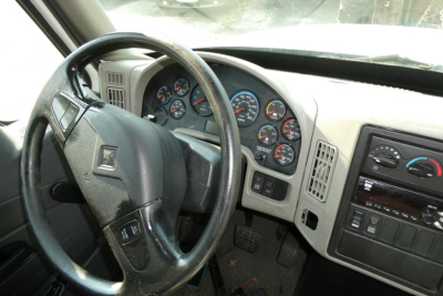 CAB interior showing steering wheel and instrument cluster of a 2017 International 4300 SBA truck.