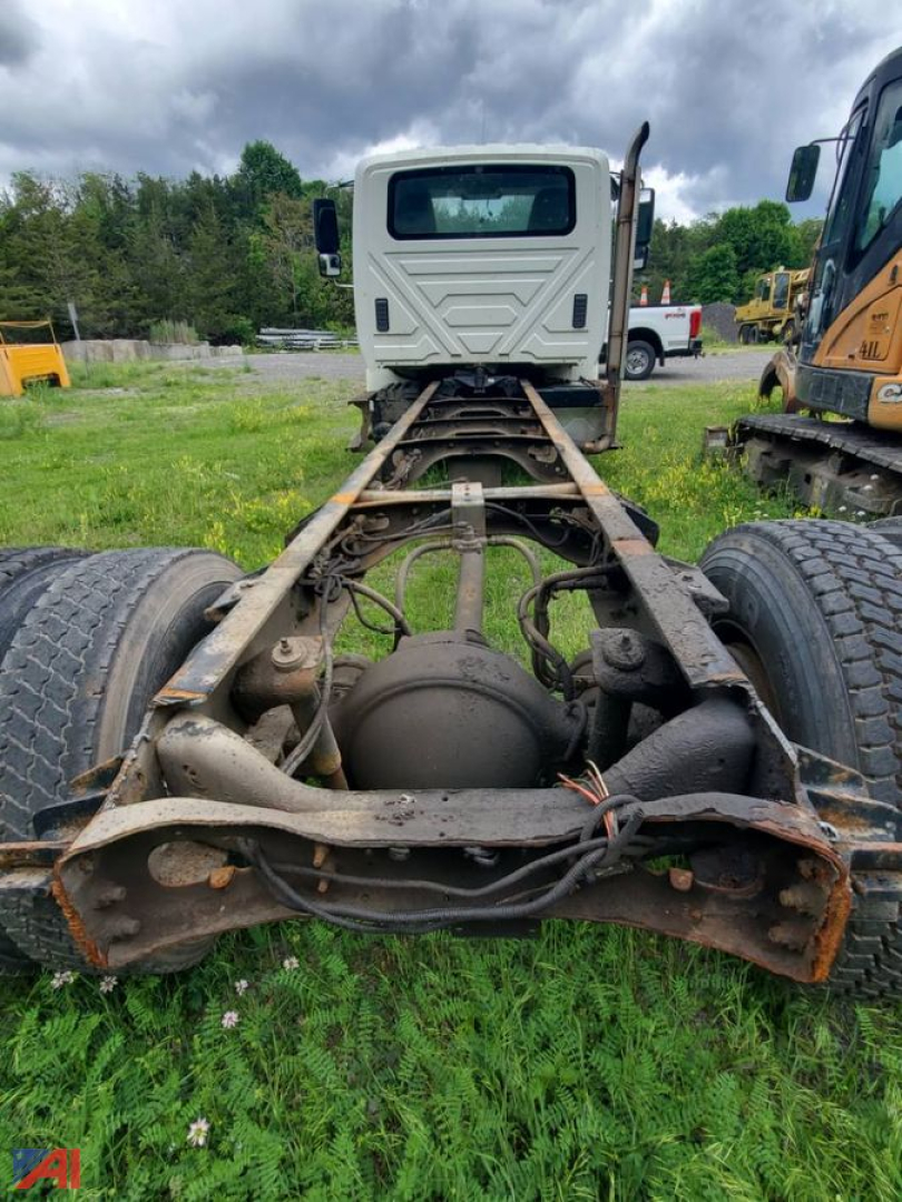 Cab and chassis rear view showing drivetrain and frame on International DuraStar truck. Visible components include rear axles, differential, leaf springs, and wiring harnesses.