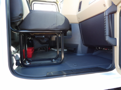 Cab interior of a 2025 Mack GR104F dump truck showing seating area and floor space.