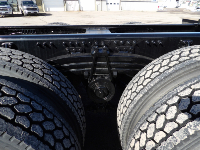 Mack GR104F chassis view showing tandem rear axle with dual tires and suspension components.