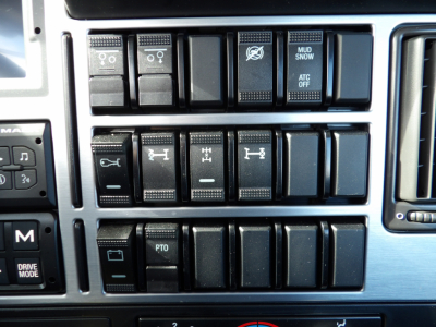 Mack GR104F dashboard control switches and gauges panel showing multiple toggles and indicators.