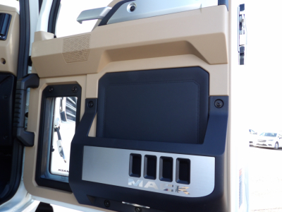 Mack GR104F door panel showing black storage pocket and metallic trim with MAX text