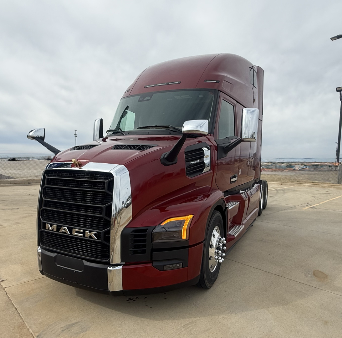 Mack PR64T76H truck front-left view showing cab and grille with chrome accents.