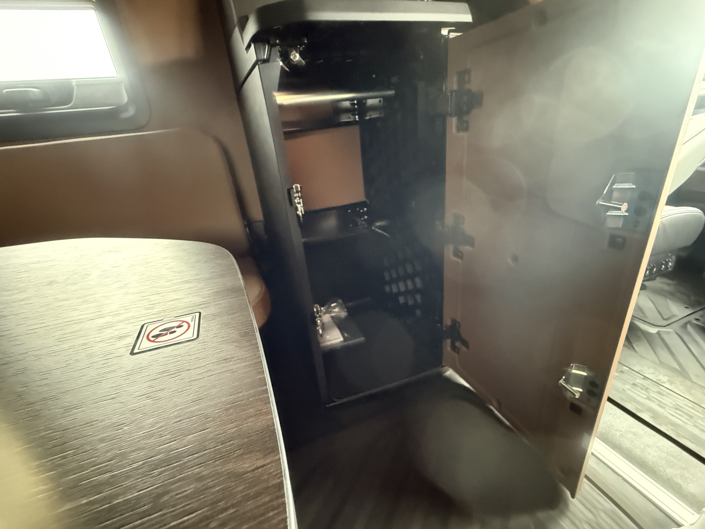 Cabinet with open doors inside a Mack PR64T76H sleeper truck showing interior storage compartments and shelves.