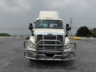 Front view of a white 2017 Freightliner Cascadia CA125DC conventional daycab truck with a large aftermarket grille guard.