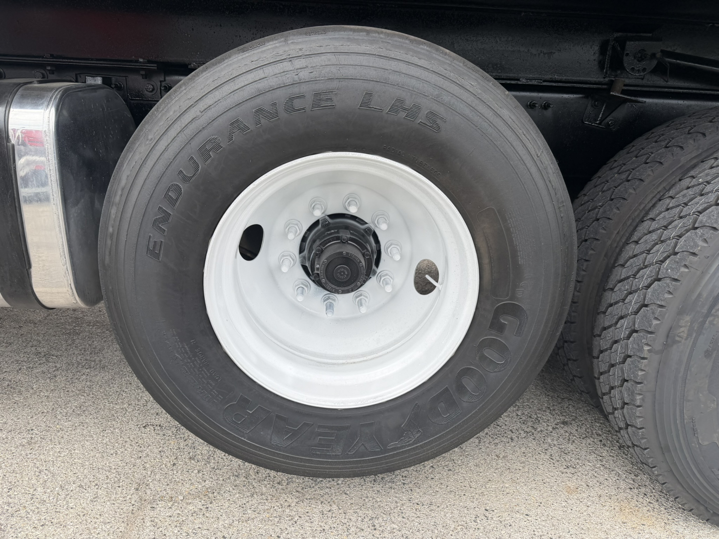 Mack GR64F wheel showing Goodyear Endurance tires and white steel rim.