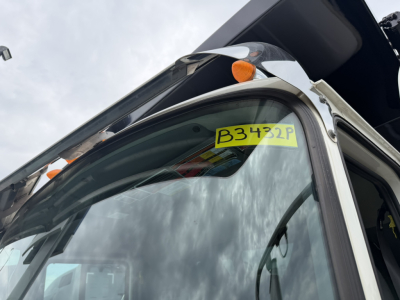 Truck cab window with yellow B3432P stock label stuck on windshield
