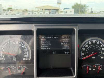 Dashboard view of a 2021 Mack GR64F dump truck showing the central display with vehicle totals and gauges on left and right.