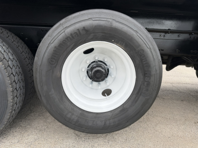 Dually truck wheel showing ContiContinental tire on white steel rim under truck chassis.