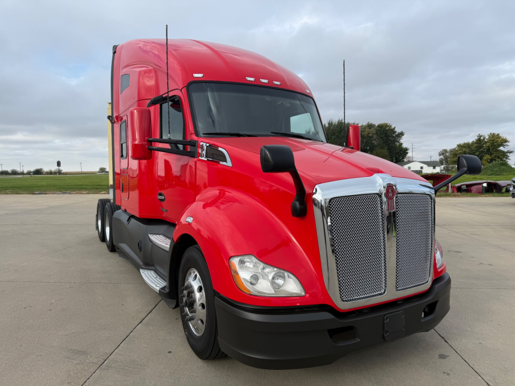 Kenworth T680 truck in red color showing front grille and cab exterior with chrome accents.