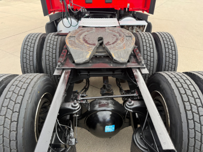 Kenworth T680 chassis with fifth wheel, dual rear axles, and drivetrain undercarriage visible