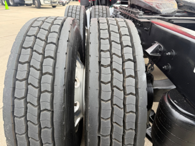 Kenworth T680 tractor rear axles showing dual tires and suspension components.