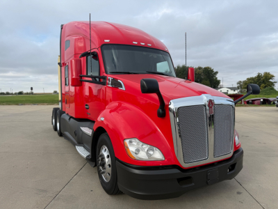 Kenworth T680 truck in red color showing front grille and cab exterior with chrome accents.
