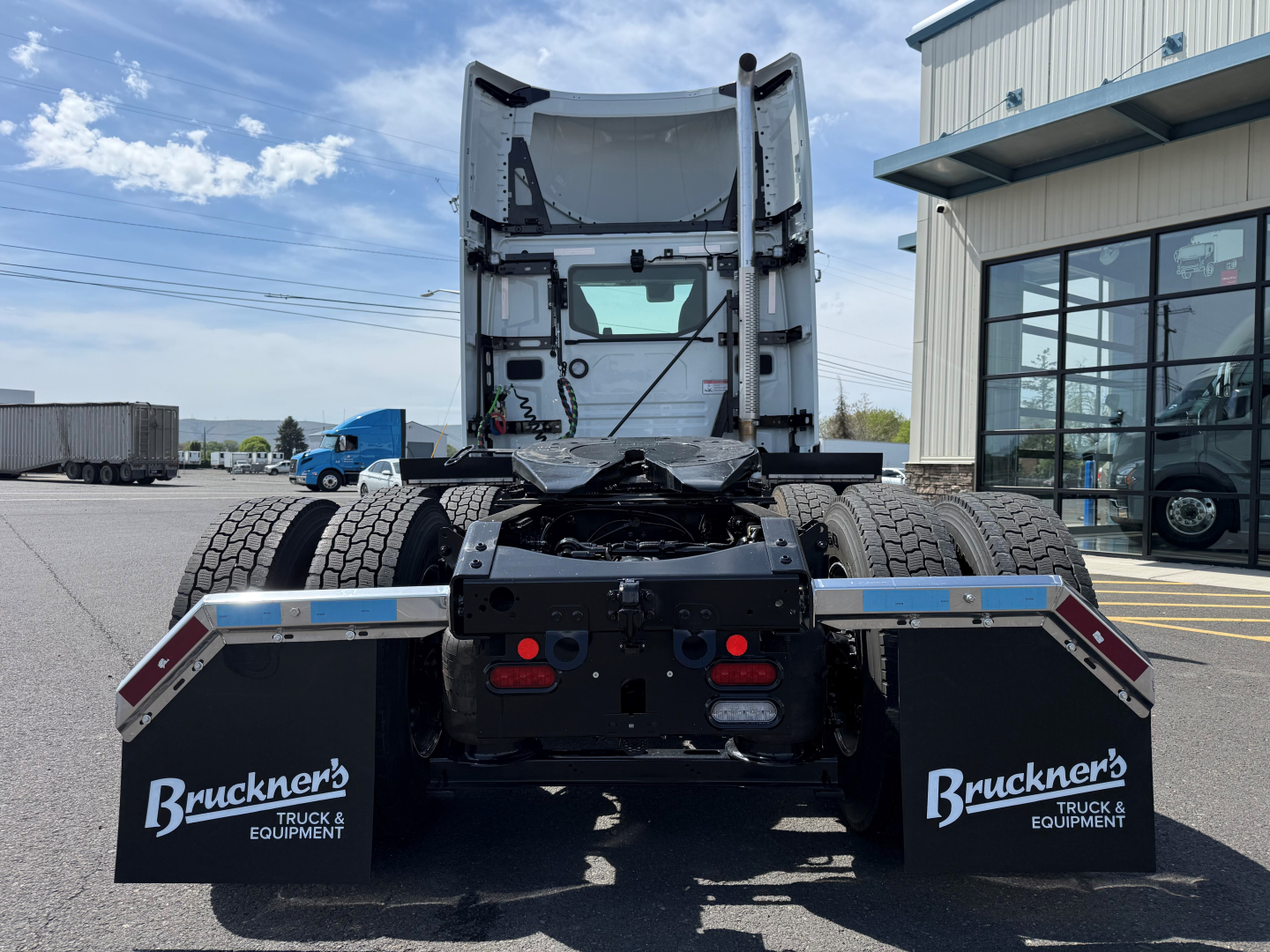 Truck chassis rear view showing fifth-wheel mount and dual rear axles with mud flaps labeled Bruckner's Truck & Equipment.