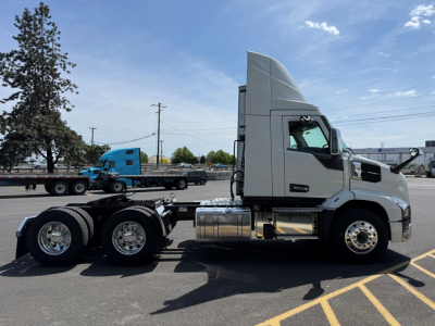 Truck chassis profile showing Mack AN64T cab and 6x4 drivetrain with silver fuel tanks and wheels; no visible labels or serial numbers readable on this side.