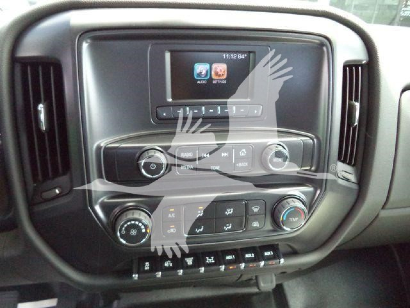 Dashboard view of a 2023 International CV truck interior with infotainment screen, control knobs, and climate controls visible.
